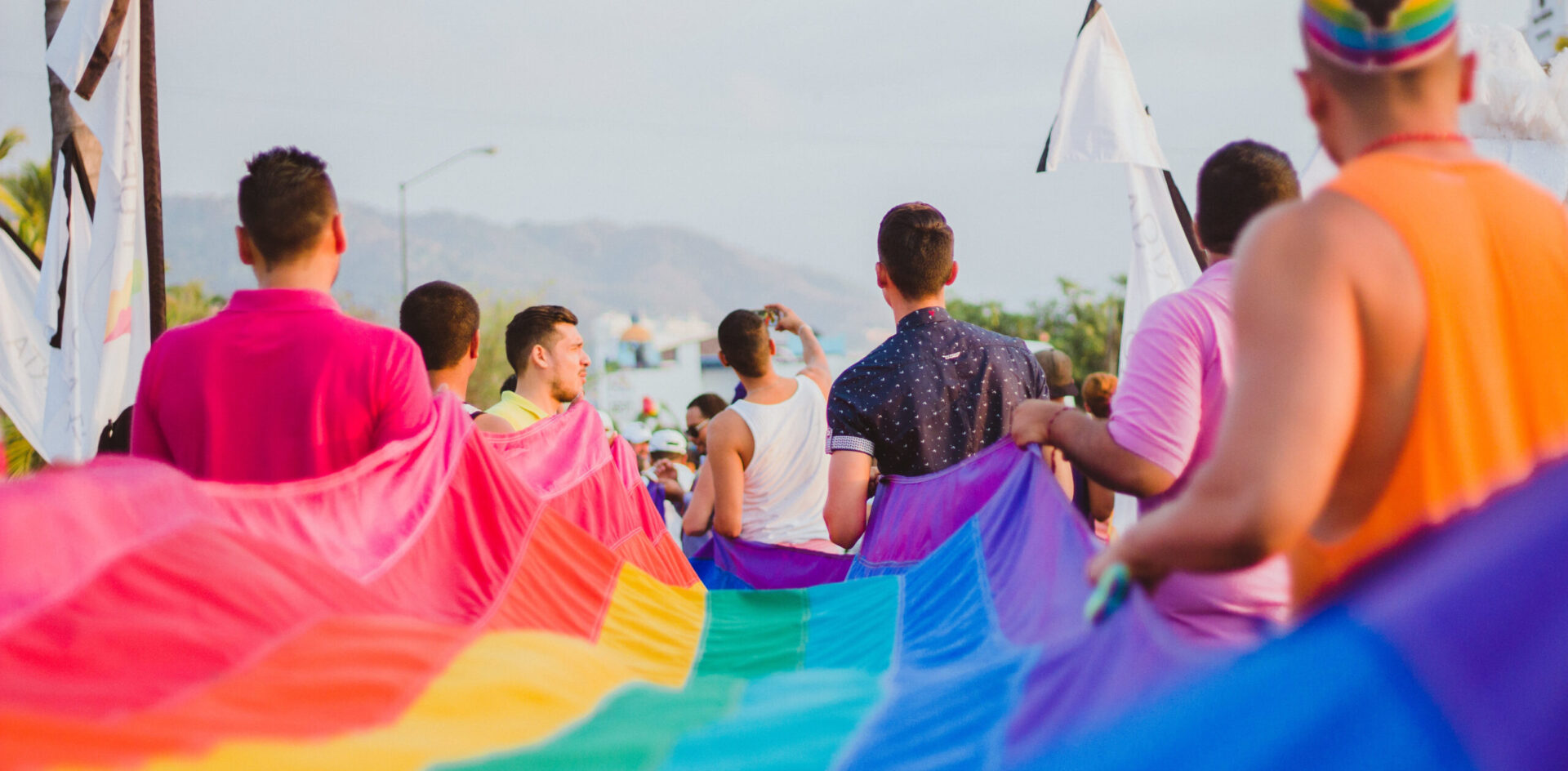 Puerto Vallarta Pride celebration crowd rainbow flags Malecón street life.